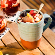 Load image into Gallery viewer, Turquoise jug with sangria on a wooden table.