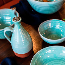Load image into Gallery viewer, Turquoise oil pourer and 4 bowls sitting on a dark wooden table