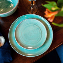 Load image into Gallery viewer, Turquoise side plate sitting on a turquoise dinner plate on a dark wooden table.