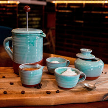 Load image into Gallery viewer, Terracotta cafetiere, mini handleless jug, 2 espresso cups and a sugar bowl sitting on a wooden borad with whole coffee beans scattered around and a metal spoon.