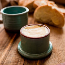 Load image into Gallery viewer, French butter keeper, turquoise glaze, butter in the lid sitting on a wooden board with buttered bread.