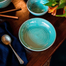 Load image into Gallery viewer, Turquoise pasta bowl on a dark table with navy napkin and soup spoon.