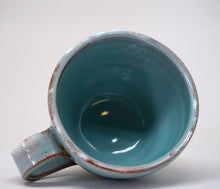 Load image into Gallery viewer, Turquoise espresso cup on it's side on a white background