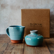 Load image into Gallery viewer, Turquoise milk jug and sugar bowl in front of a brown gift box