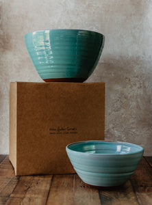 2 large turquoise pottery bowls and a brown gift box