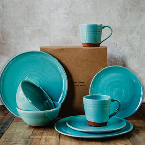 Turquoise pottery in front of a brown gift box